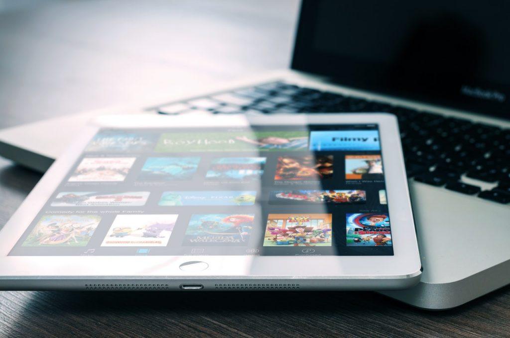 ipad sitting on top of a laptop